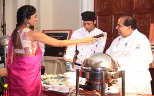 The host Laxmi Rebecca interacting with Chef Nimish Bhatia during Cook-a-thon