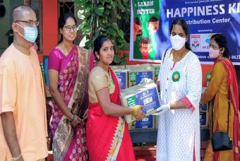 Parents visit the distribution centre to collect the happiness kits