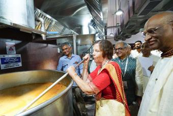 Ms. Linda Thakkar, Vice-Chairman of the Thakkar Family Foundation stirs the dal at the kitchen.