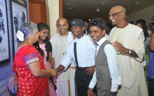 Chief Guest, Mrs. Sudha Murty (left), exchanging greetings with the three Akshaya Patra beneficiaries at the launch event 