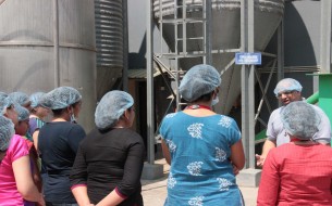 Anilkumar T.B. explaining to the group of volunteers, how the Rice Master Silo at this gravity-flow-based kitchen works