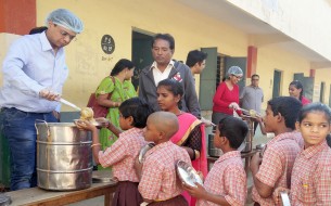 The kids of Government Higher Primary School, Konunkunte, Bengaluru, queue up eagerly for their meal, served by Mr Bansal